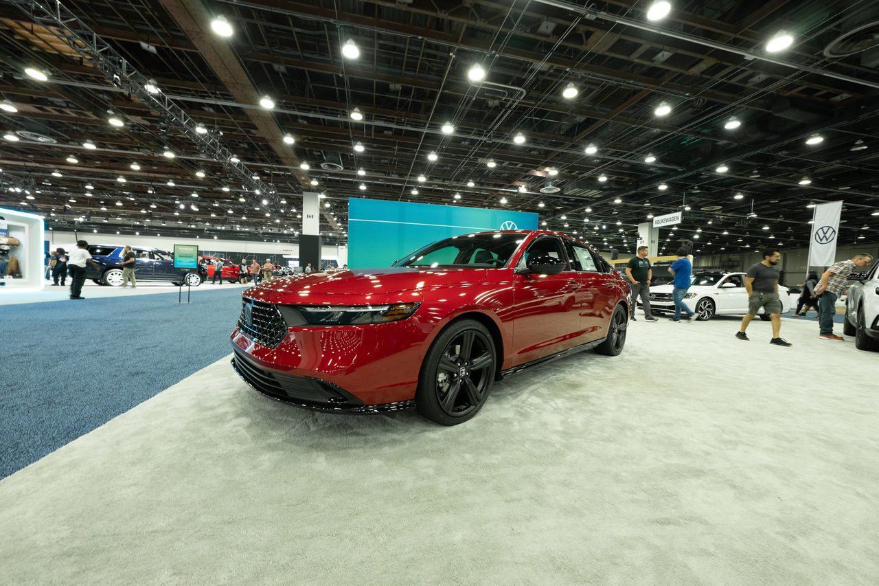 car, vehicle, land vehicle, mode of transportation, auto show, transportation, motor vehicle, indoors, exhibition, automobile, sports, snow, cold temperature, red, winter, luxury vehicle, architecture, illuminated, sports car