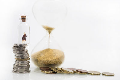 Close-up of coins on table against white background