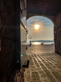 Scenic view of street against sky during sunset