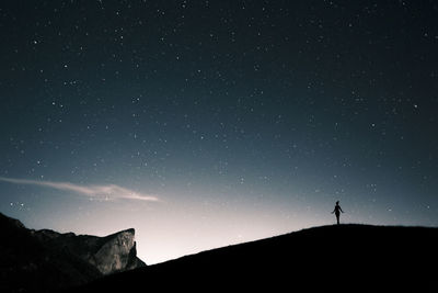 Austria, mondsee, silhouette of woman standing under starry sky