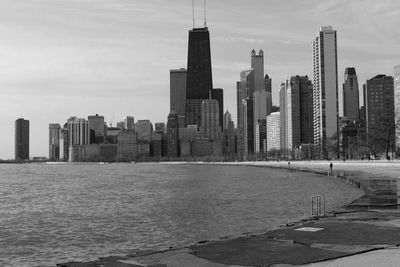 Scenic view of lake michigan and cityscape against sky