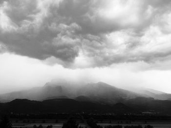 Scenic view of lake against cloudy sky