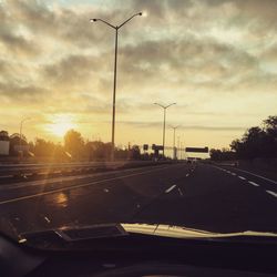 Cars on road at sunset