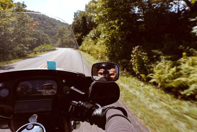 Portrait of man riding motorcycle on road