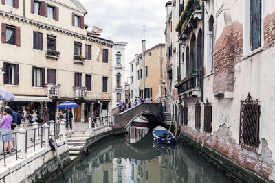 Panoramic view of canal amidst city against sky