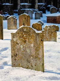 Close-up of snow covered cemetery