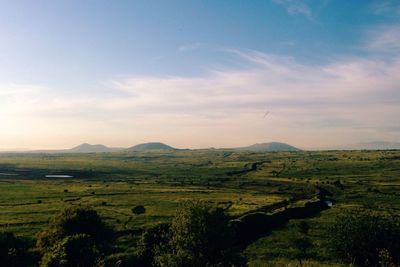 Scenic view of landscape against cloudy sky