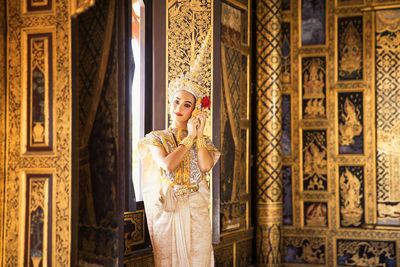 Portrait of young woman standing at home