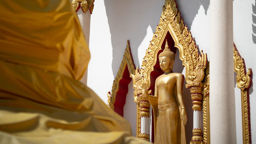 Low angle view of statue against temple building