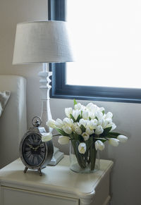 Flower vase on table at home