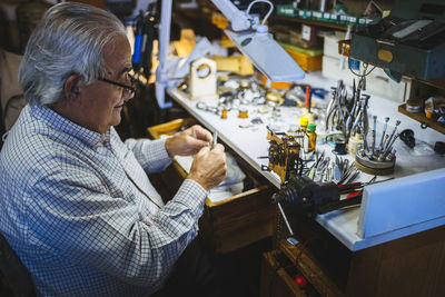 Watchmaker working in watchmaking