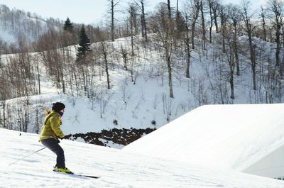 Full length of man standing on snow covered landscape