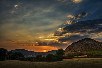 Scenic view of field against sky during sunset