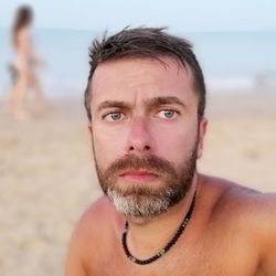 Close-up portrait of shirtless man