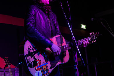 Man playing guitar at music concert