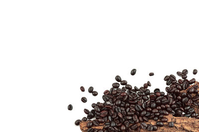 High angle view of coffee beans against white background