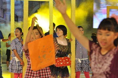 Artists performing dance with shopping bags during carnival