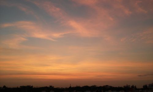 Scenic view of silhouette trees against sky at sunset