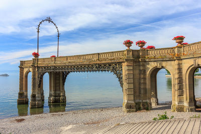 View of bridge over river against cloudy sky