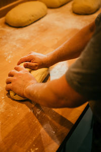 Cropped hands of man preparing food on table