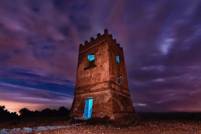 Low angle view of abandoned building against sky