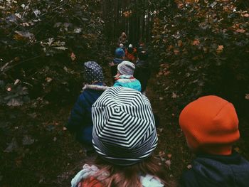 People walking amidst trees in forest