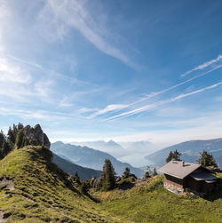 Scenic view of mountain range against cloudy sky