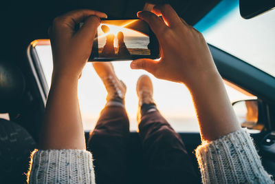 Low section of woman using mobile phone