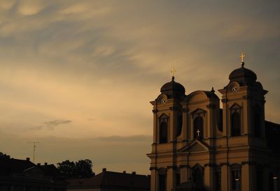 Low angle view of silhouette building against sky at sunset