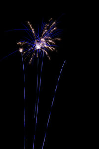 Low angle view of firework display at night