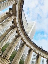 Low angle view of modern building against cloudy sky