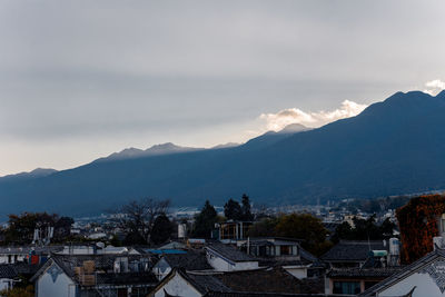 High angle view of townscape and mountains against sky