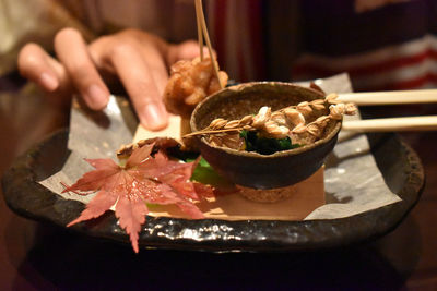 Close-up of person holding ice cream in bowl