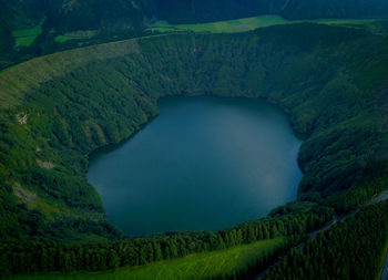 High angle view of lake amidst field against sky