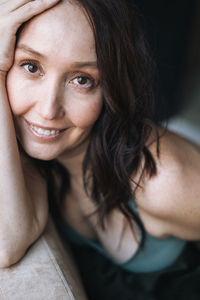 Close up portrait of smiling adult brunette woman in underwear