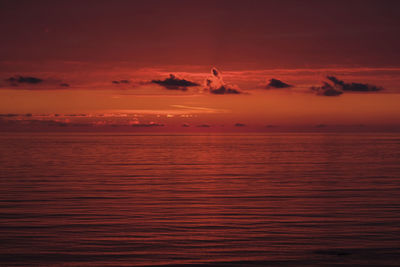 Scenic view of sea against romantic sky at sunset