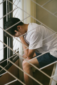 Side view of young man looking at home