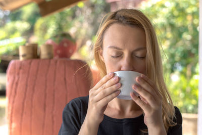 Woman drinking coffee outdoors