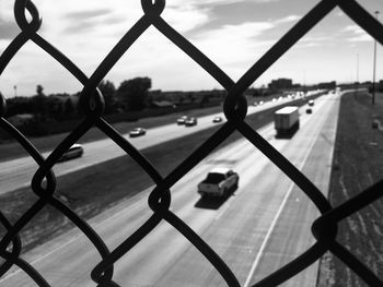 Close-up of chainlink fence against sky