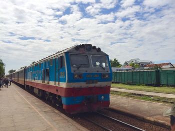 Train at railroad station against sky