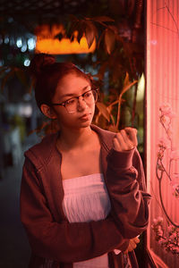 Thoughtful teenage girl standing in corridor