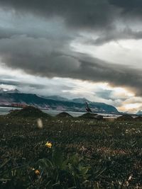 Scenic view of land and mountains against sky