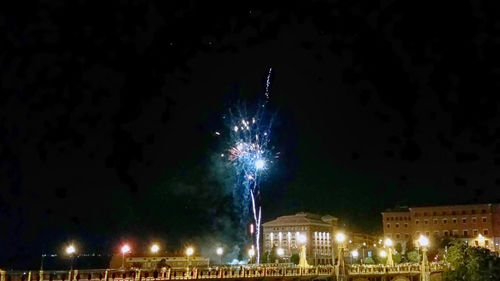 Low angle view of firework display at night