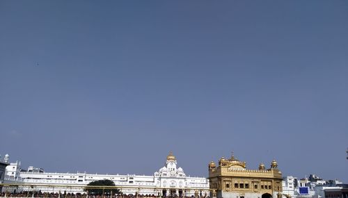 Low angle view of buildings against blue sky