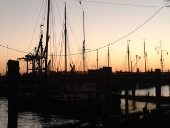 Boats in harbor at sunset