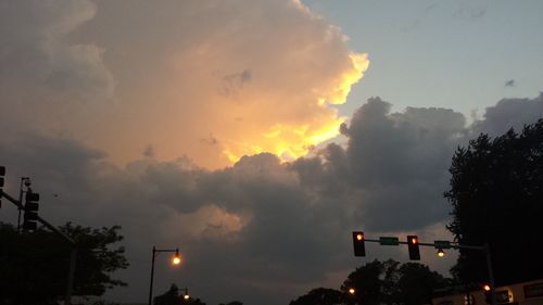 Low angle view of illuminated street light against sky