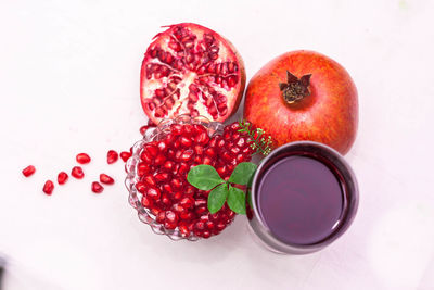 High angle view of fruits on table against white background