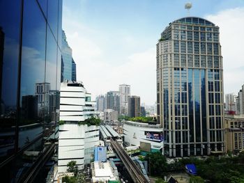 Modern buildings in city against sky