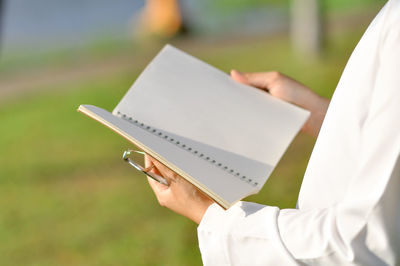 Close-up of hand holding book