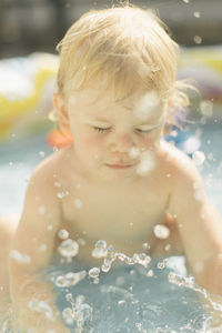 Close-up of boy swimming in water